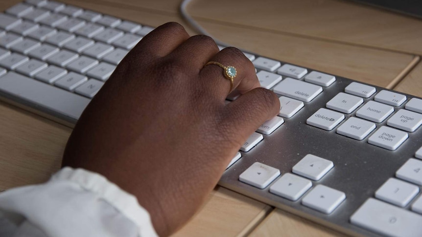 Good generic of an African Australian woman's hand on a computer keyboard