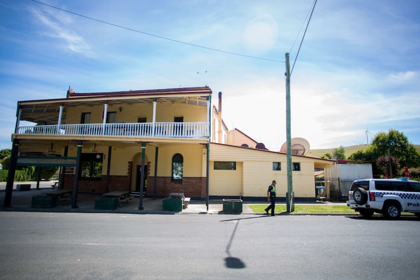 Policeman Paul Delaney steps from the Toora pub to his car.