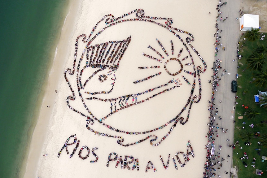 Around 1500 people form an image on Flamengo beach in Rio de Janeiro, Brazil.