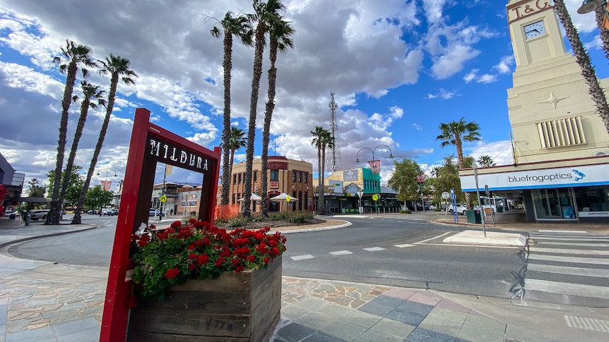 A planter box with a sign above it saying "Mildura" in a pleasant-looking plaza.