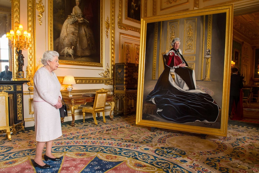 Queen Elizabeth stands in front of a large portrait of herself