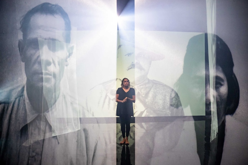 Cathy Freeman looks at photos of ancestors.