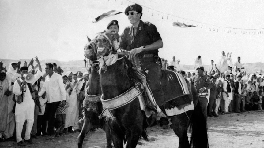 Moamar Gaddafi on horseback in 1975