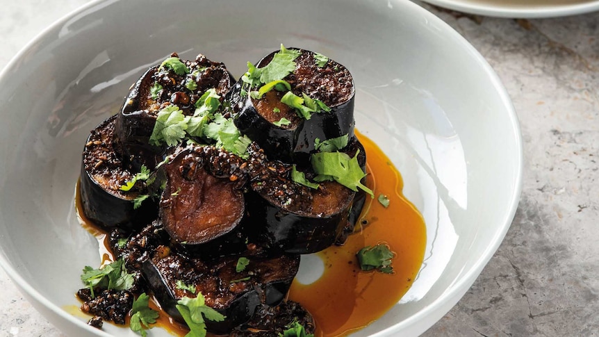 A dish of Tamarind Eggplant scattered with coriander
