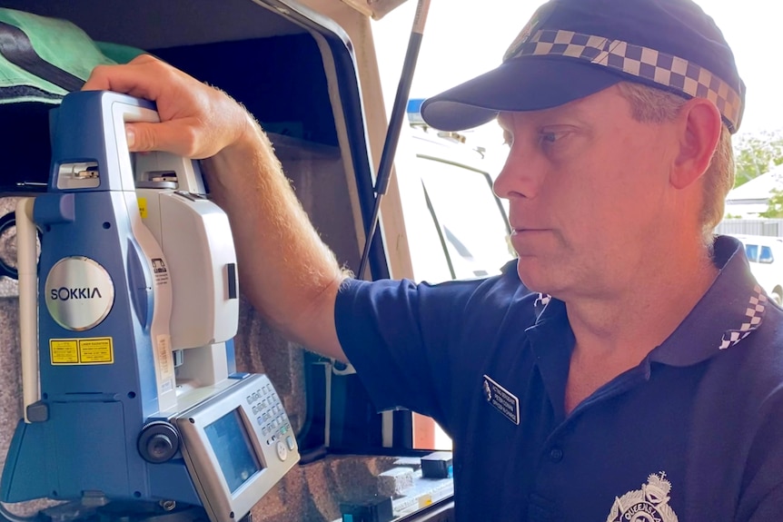 Police officer looking at equipment in the truck