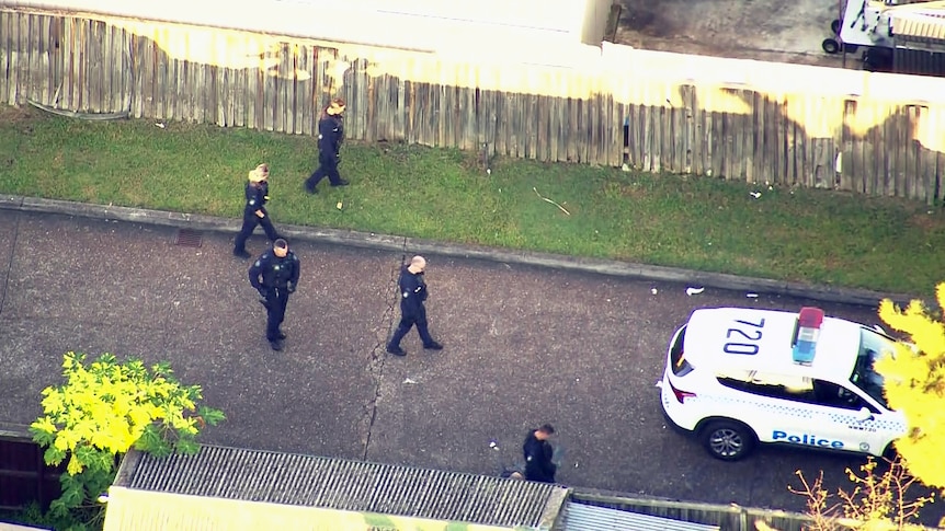 nsw police officers conduct a line search after multiple stabbings in doonside