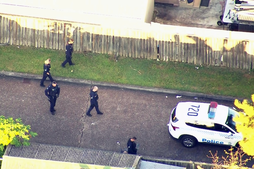 nsw police officers conduct a line search after multiple stabbings in doonside