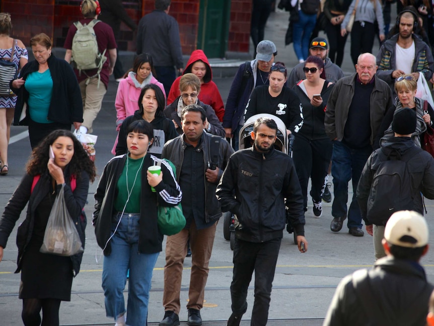 People walking in the Melbourne CBD on a cold day.