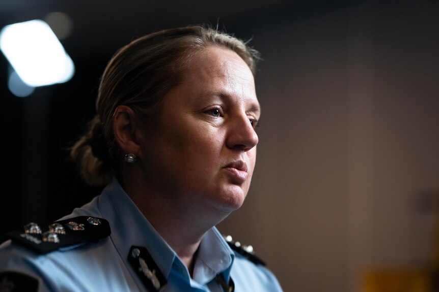 A woman talking to someone off-camera while wearing a police uniform.