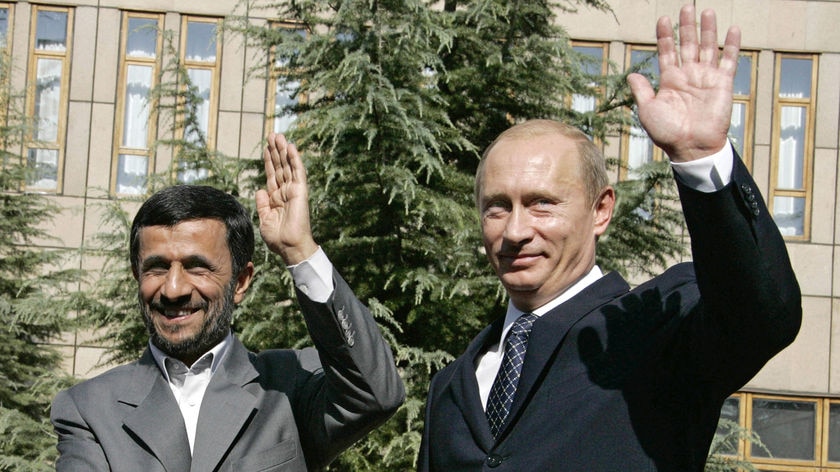 Close ties: Iranian President Mahmoud Ahmadinejad and Russian President Vladimir Putin shake hands in Tehran on Tuesday