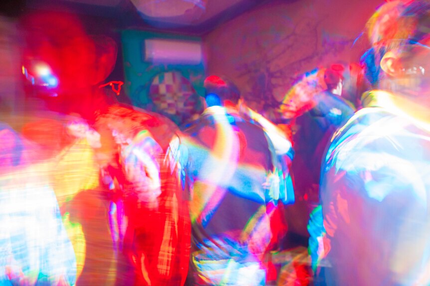 Blurred photo of people at a nightclub with bright colours