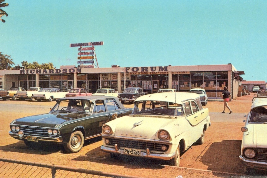 Vintage cars outside a shopping centre in Port Hedland with blue skies