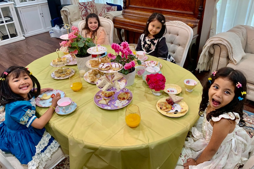 four girls sit around a table