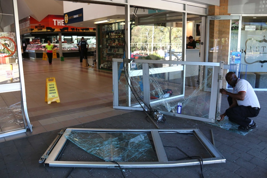 Damaged glass sliding doors at the Kaleen shops.