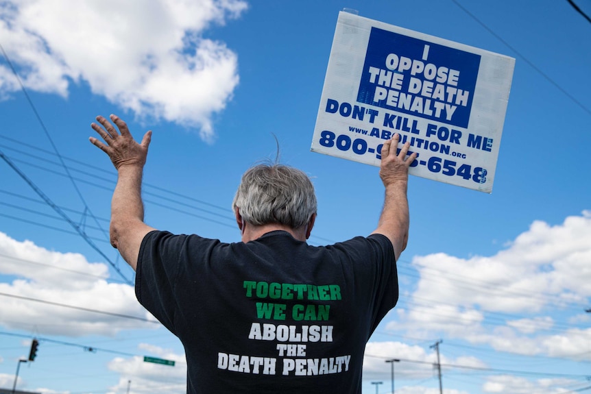 Protesters against the death penalty gather nearby where Daniel Lewis Lee was executed.