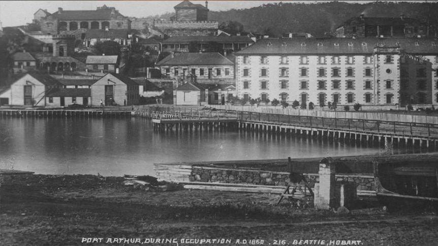 Old photo of buildings by water, text reads "Port Arthur during occupation AD.1860, 216, Beattie, Hobart"