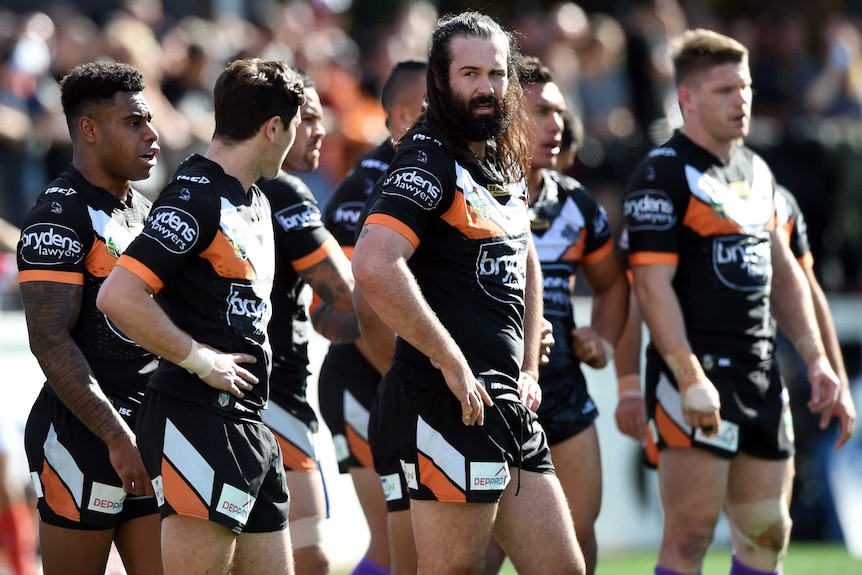Wests Tigers look on after a try from the Canberra Raiders