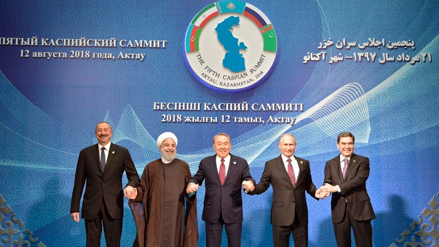 Vladimir Putin, Nursultan Nazarbayev, Gurbanguly Berdimuhamedow, Ilham Aliyev and Hassan Rouhani stand in a row.
