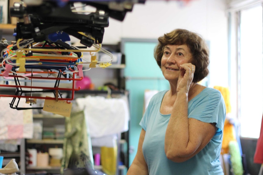 A woman with second hand clothing.