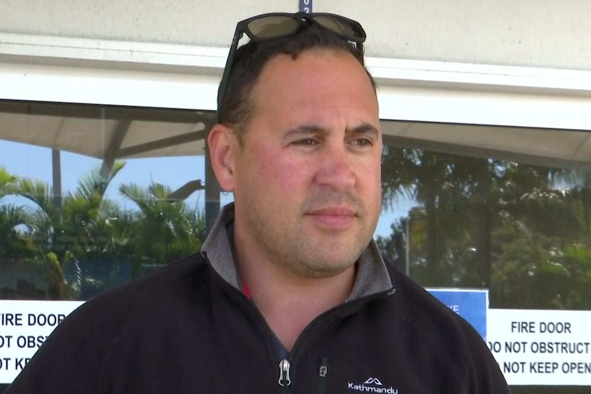 A man standing outside an airport