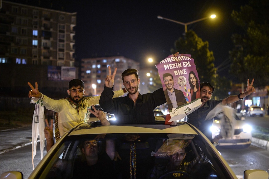 A supporter of pro-Kurdish Peoples' Democratic Party (HDP) celebrates with friends