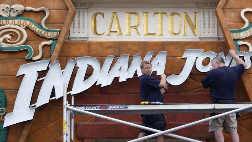 Workmen erect an Indiana Jones sign in Cannes