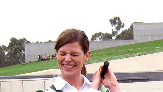 Sports minister Kate Ellis grimaces after playing a chip shot on the front lawn of Parliament House