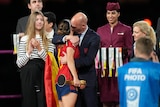 President of Spain's soccer federation, Luis Rubiales, right, hugs Spain's Aitana Bonmati.