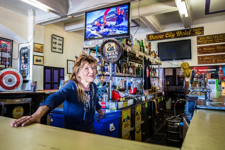 A publican behind the bar of her country hotel.