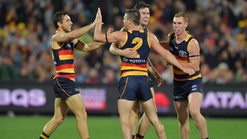 Adelaide Crows' Brad Crouch celebrates a goal with teammates against GWS at Adelaide Oval.