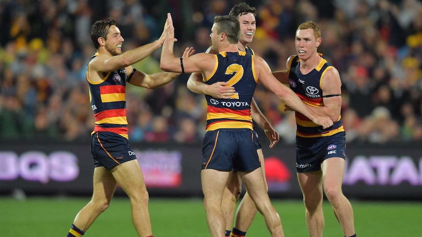 Brad Crouch celebrates a goal with his Crows teammates against GWS