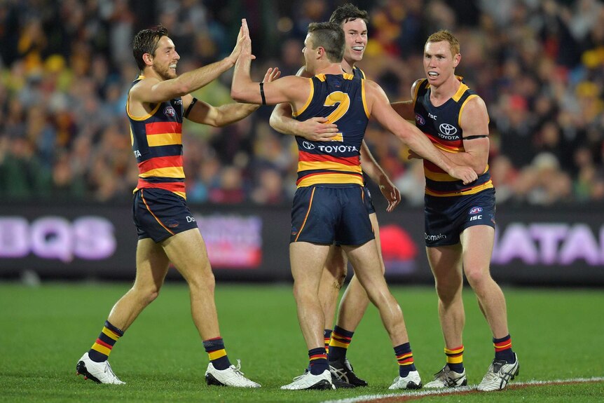 Brad Crouch celebrates a goal with his Crows teammates against GWS