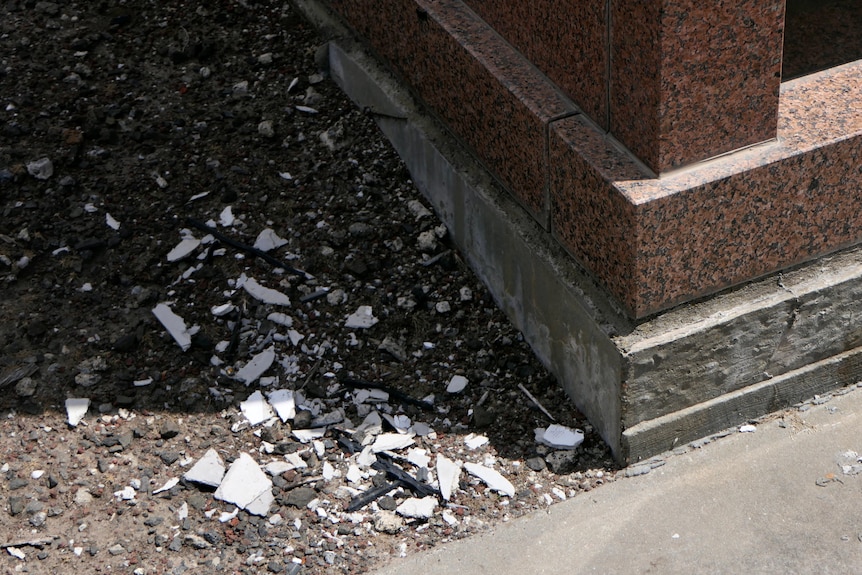 Broken pieces of ceramic on the ground.