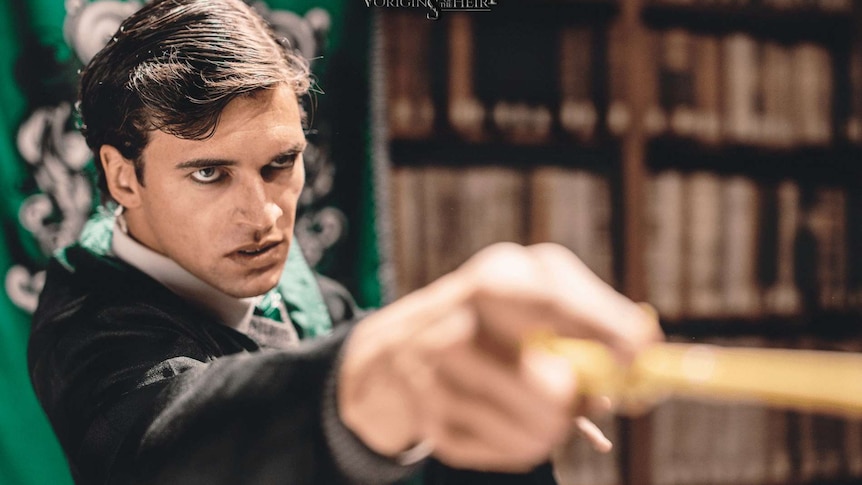 Tom Marvolo Riddle points a wand.