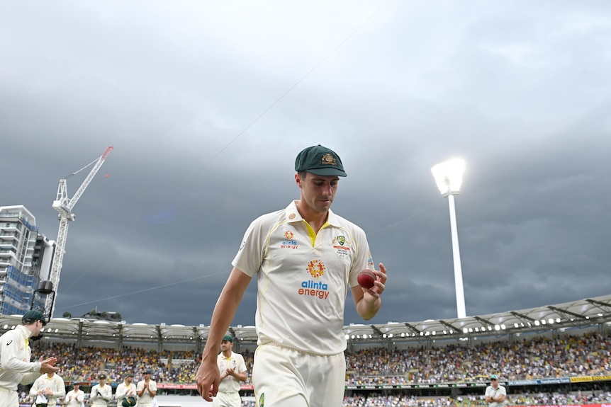 Pat Cummins walks off the Gabba on day one of the Ashes