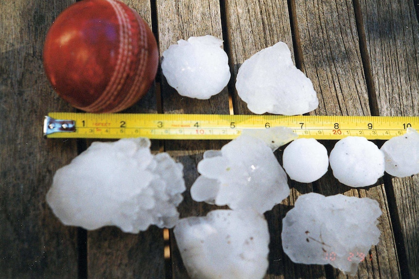 Hail measured up against a ruler.