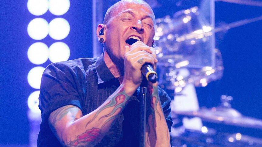Linkin Park singer Chester Bennington sings on stage.