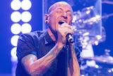 Linkin Park singer Chester Bennington sings on stage.