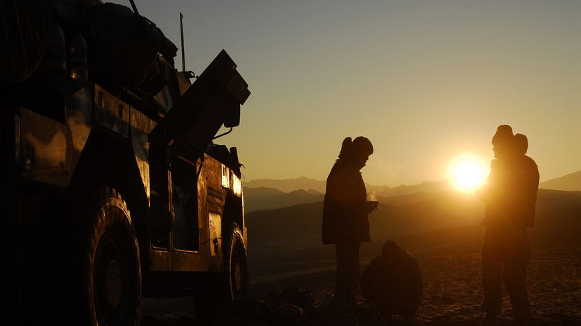 Australian soldiers stand next to their armoured tank in southern Afghanistan