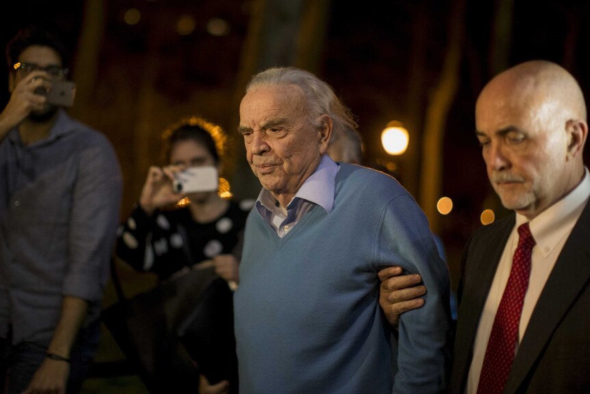 Jose Maria Marin is escorted out of court.