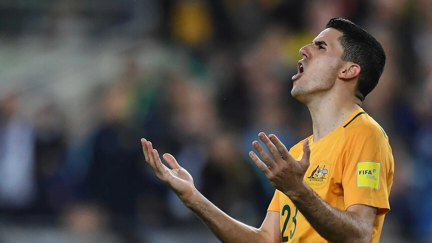 Tom Rogic reacts with his hands in the air after missing a scoring chance