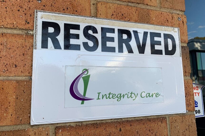 A white sign with the words 'reserved integrity care' displayed on it