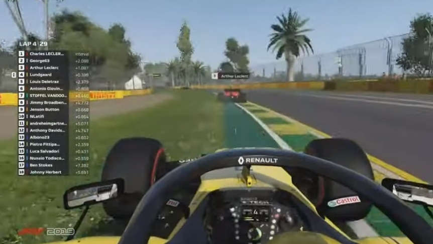 A scene from above a Formula 1 esports race, with a name hovering above the car in front