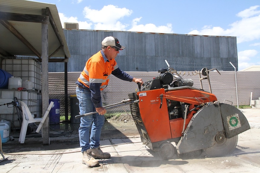 a man working a drill machine