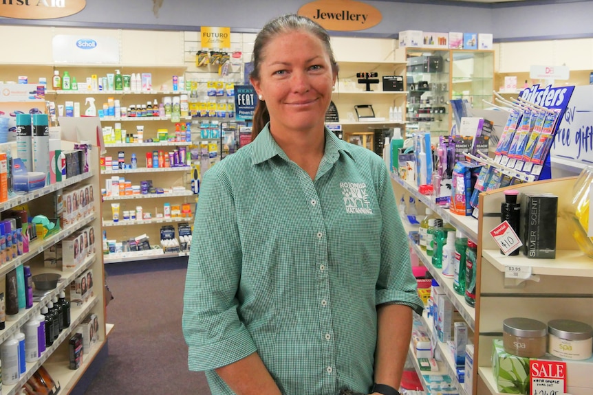 a woman standing in a pharmacy