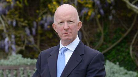 London councillor Nicholas Paget-Brown, stands with his hands clasped in front of him.