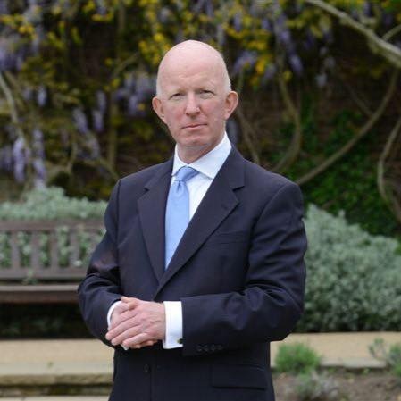 London councillor Nicholas Paget-Brown, stands with his hands clasped in front of him.