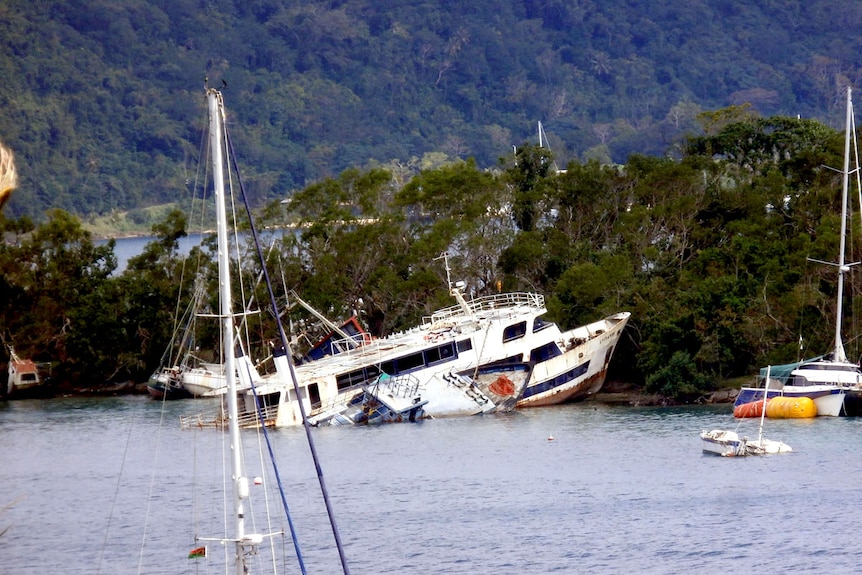 Damaged tourist boats in Vila Bay.