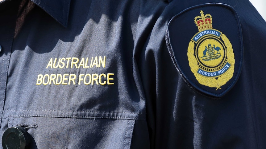 Australian Border Force logos are seen on the uniform of an officer in Brisbane, Thursday, Sept. 3, 2015.