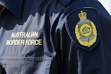 Australian Border Force logos are seen on the uniform of an officer in Brisbane, Thursday, Sept. 3, 2015.